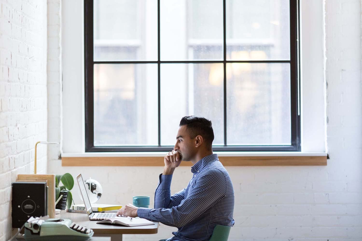 A man solving problems on a laptop