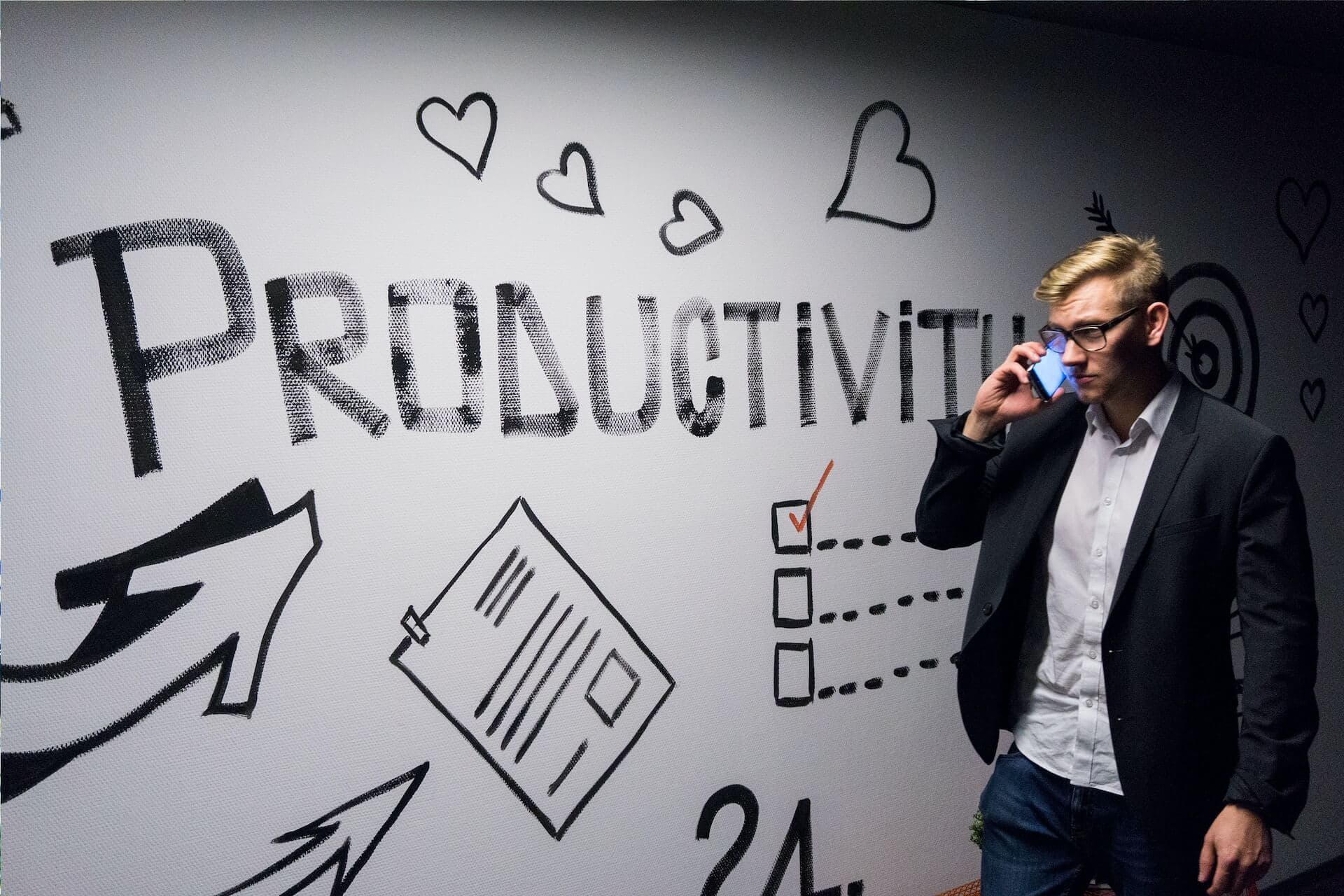 Productivity is written on a white board with a man standing next to it